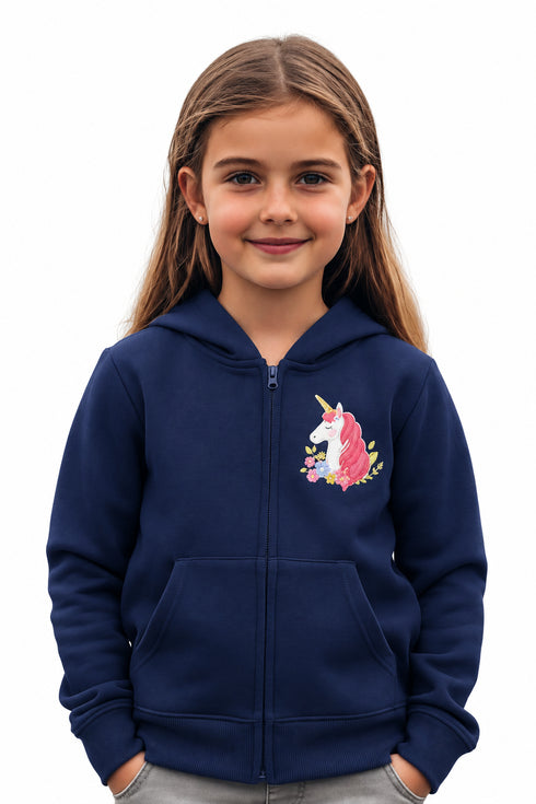 Young girl wearing a dark blue hoodie with a unicorn design on a plain background