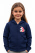 Young girl wearing a dark blue hoodie with a unicorn design on a plain background